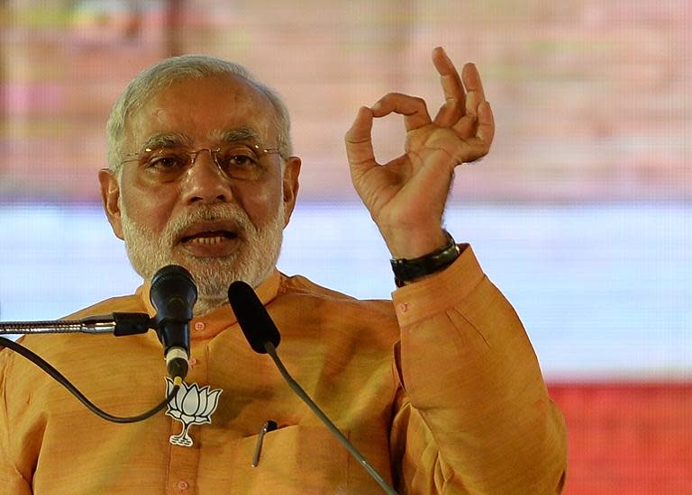 Indian Prime Minister and Bharatiya Janata Party leader Narendra Modi gestures as he speaks during a public rally in Mumbai on October 4, 2014