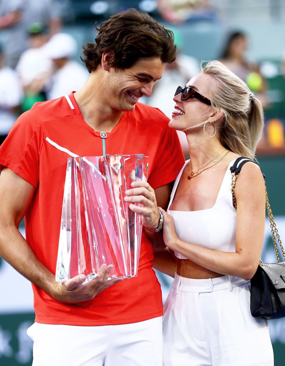 Taylor Fritz of the United States holds his winners trophy with his girlfriend Morgan Riddle after his straight sets victory against Rafael Nadal of Spain in the men's Final on Day 14 of the BNP Paribas Open at the Indian Wells Tennis Garden on March 20, 2022 in Indian Wells, California