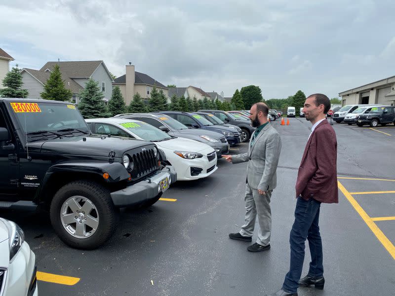 Alex Tovstanovsky, owner of used-car dealer Prestige Motor Works, checks on depleted inventory in Naperville