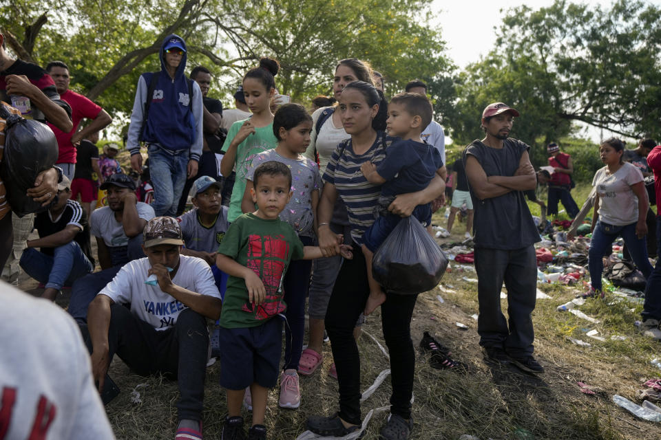 Migrants arrive at the Rio Grande river bank with plans to cross to the U.S. side from Matamoros, Mexico, Wednesday, May 10, 2023. The U.S. on May 11 will begin denying asylum to migrants who show up at the U.S.-Mexico border without first applying online or seeking protection in a country they passed through, according to a new rule released on May 10. (AP Photo/Fernando Llano)