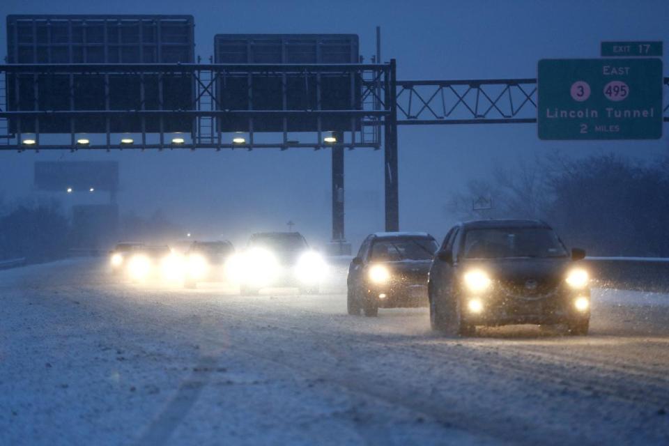 Vehicles commute under snowfall northbound on the New Jersey Turnpike, Saturday, Dec. 17, 2016, in Ridgefield, N.J. (AP Photo/Julio Cortez)