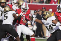 Utah running back Tavion Thomas (9) is tackled by Colorado safety Mark Perry (5), defensive end Mustafa Johnson (34) and linebacker Devin Grant (44) in the first half of an NCAA college football game Friday, Nov. 26, 2021, in Salt Lake City. (AP Photo/George Frey)