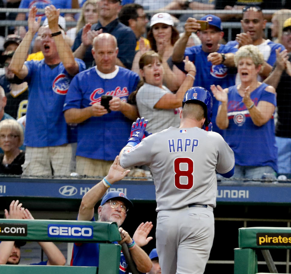 Chicago Cubs' Ian Happ (8) is greeted by manager Joe Maddon, left, and cheering Cubs fans after hitting a solo home run against the Pittsburgh Pirates during the fourth inning of a baseball game Thursday, Aug. 16, 2018, in Pittsburgh. (AP Photo/Keith Srakocic)