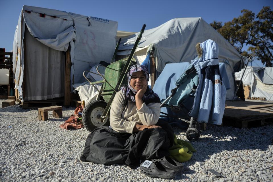 A migrant sits at Karatepe refugee camp, on the northeastern Aegean island of Lesbos, Greece, Thursday, Nov. 25, 2021. Pope Francis is heading back to the Greek island of Lesbos to meet migrants and asylum seekers for the second time in five years. (AP Photo/Panagiotis Balaskas)