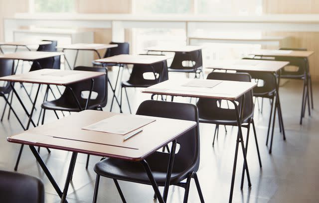 Getty Stock image of tests on desks in empty classroom