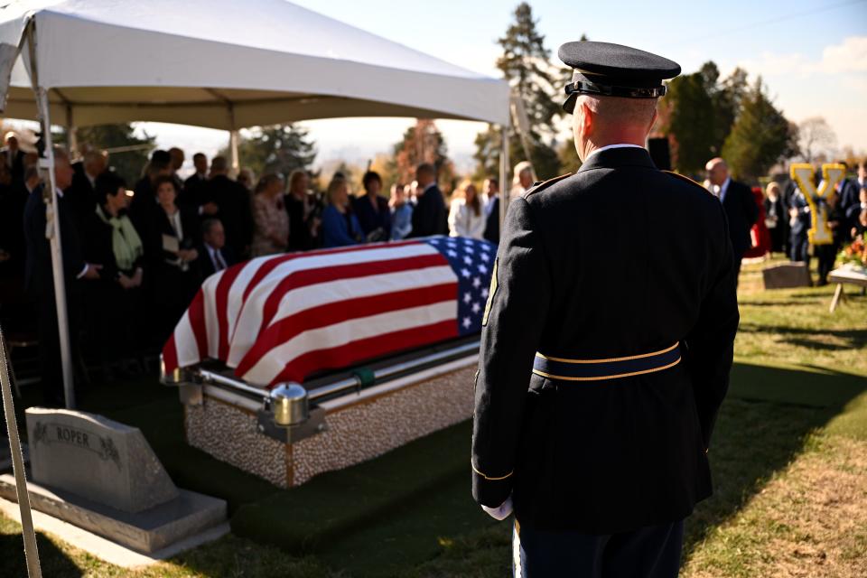 A member of the military stands at the front near the casket of President M. Russell Ballard’s casket as the graveside service begins in the Salt Lake City Cemetery on Friday, Nov. 17, 2023. | Scott G Winterton, Deseret News