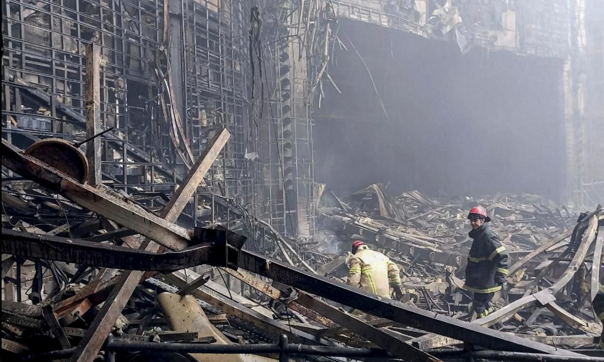 <span>Russian rescuers clear the rubble and extinguish fires at Moscow's Crocus City Hall.</span><span>Photograph: Russian Emergencies Ministry Handout/EPA</span>