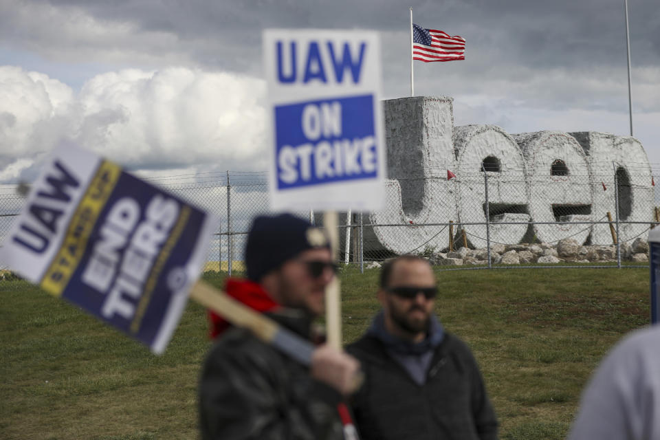 File - Striking UAW workers picket at the Jeep Assembly Plant on Oct. 9, 2023 in Toledo, Ohio. The UAW contends that the furloughs by Detroit's three automakers were not necessary and are being done in an effort to push members to accept less in contract negotiations. (Jonathan Aguilar/The Blade via AP, File)