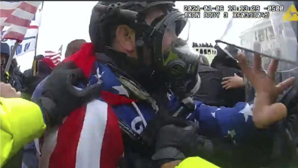 In this image from U.S. Capitol Police video, released and annotated by the Justice Department in the sentencing memorandum, Christopher Quaglin, appears on police body-worn camera footage at the U.S. Capitol on Jan. 6, 2021, in Washington. Quaglin, a New Jersey electrician who repeatedly attacked police officers during the siege at the U.S. Capitol, has been sentenced to 12 years in prison. (Justice Department via AP)