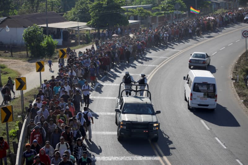 Migrants, mainly from Central America and marching in a caravan, walk on a road near Ignacio Zaragoza, Chiapas