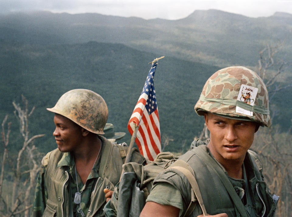 Two marines, one carrying the American flag in his backpack, in December 1969. (AP Photo)