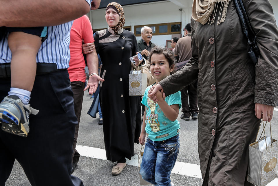 A Syrian migrant family arrives at Subang Air Force base in Subang, outside Kuala Lumpur on May 28, 2016.  Malaysia on May 28 received 68 Syrian refugees including 31 children out of a total of 3,000 it hopes to allow into the predominantly Muslim country with hundreds more expected soon. / AFP / STR / Malaysia OUT        (Photo credit should read STR/AFP/Getty Images)