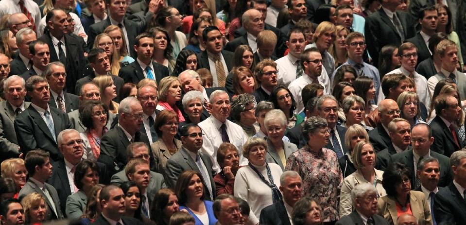 People look on during opening session of the two-day Mormon church conference Saturday, April 5, 2014, in Salt Lake City. More than 100,000 Latter-day Saints are expected in Salt Lake City this weekend for the church's biannual general conference. Leaders of The Church of Jesus Christ of Latter-day Saints give carefully crafted speeches aimed at providing members with guidance and inspiration in five sessions that span Saturday and Sunday. They also make announcements about church statistics, new temples or initiatives. In addition to those filling up the 21,000-seat conference center during the sessions, thousands more listen or watch around the world in 95 languages on television, radio, satellite and Internet broadcasts. (AP Photo/Rick Bowmer)