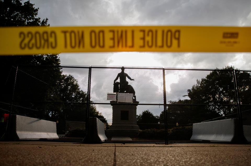 Yellow police tape, concrete barricades and fencing surround the Emancipation Memorial in Lincoln Park in Washington, Thursday, June 25, 2020. The Emancipation Memorial depicts a freed slave kneeling at the feet of President Abraham Lincoln. Calls are intensifying for the removal of the statue as the nation confronts racial injustice.