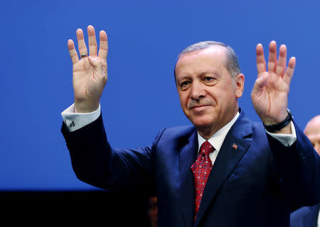 Turkish President Tayyip Erdogan greets the audience during a meeting at the Presidential Palace in Ankara, Turkey, August 24, 2016. Kayhan Ozer/Presidential Palace/Handout via REUTERS