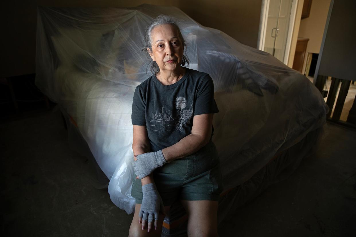 Lydia Duran, 68, sits on the corner of her bed in the Spanish Walk neighborhood in Palm Desert. Her condo suffered major damage in Tropical Storm Hilary.