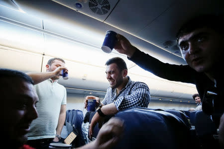 Armenians celebrate during a flight from Kiev, Ukraine, to Yerevan, Armenia, after Armenian Prime Minister Serzh Sarksyan resigned following almost two weeks of mass street protests, April 23, 2018. REUTERS/Gleb Garanich