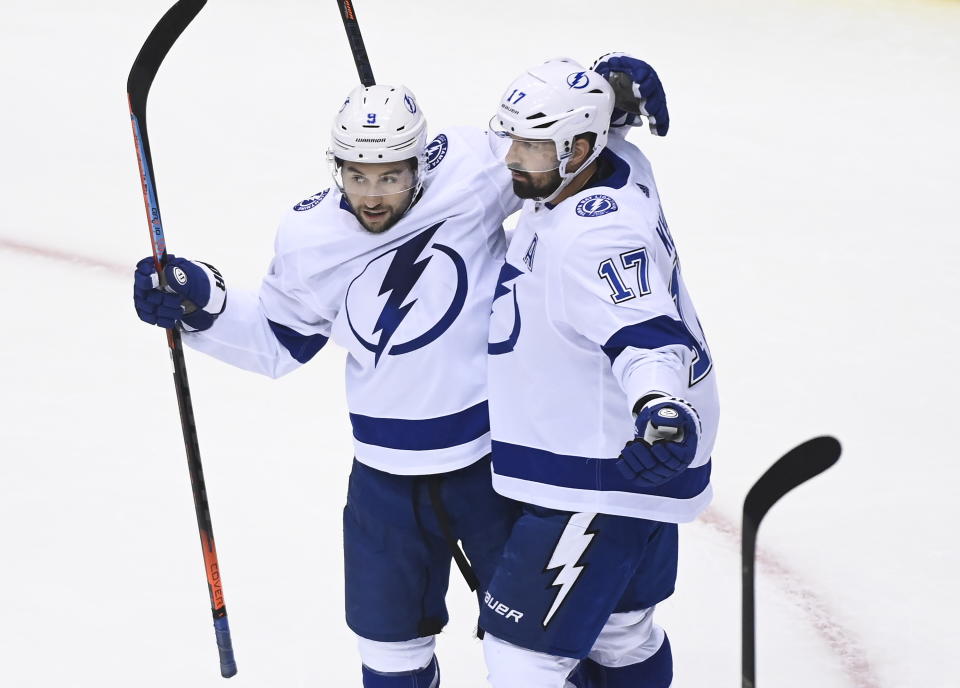 Tampa Bay Lightning left wing Alex Killorn (17) celebrates his goal with teammate Tyler Johnson (9) while playing against the Boston Bruins during the first period of an NHL hockey playoff game Wednesday, Aug. 5, 2020 in Toronto. (Nathan Denette/The Canadian Press via AP)