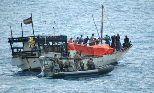 Australian Navy sailors prepare to board a dhow which had been seized by Somali pirates at sea off the Horn of Africa