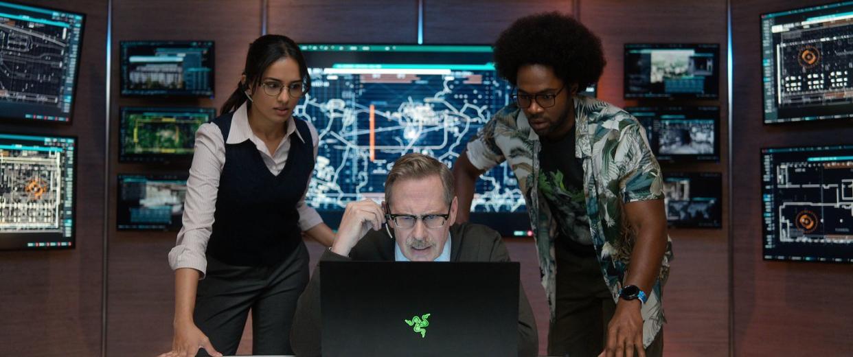 fubar l to r aparna brielle as tina mukerji, scott thompson as dr louis pfeffer, milan carter as barry putt in episode 107 of fubar cr courtesy of netflix © 2023