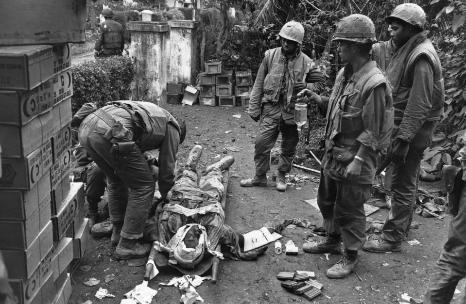 <p>A wounded American soldier being attended to on February 19, 1968 during the Vietnam war. (Photo: Terry Fincher/Daily Express/Hulton Archive/Getty Images) </p>