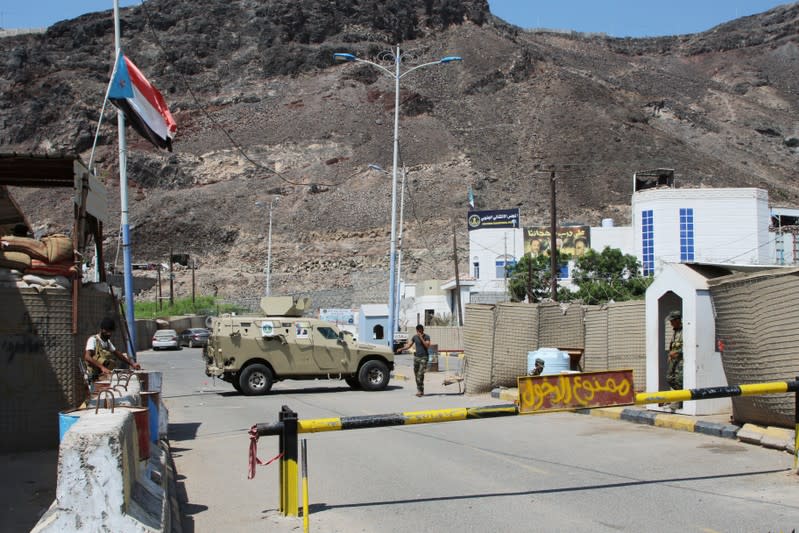 Southern Yemeni separatist fighters stand guard outside the headquarters of the Southern Transitional Council in Aden