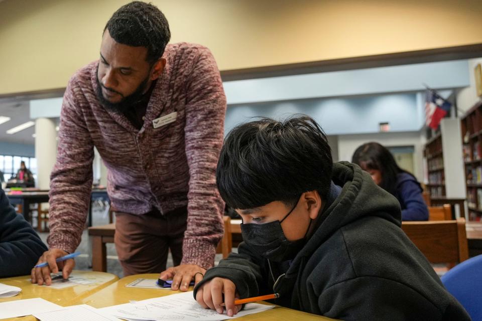 Mendez Middle School Assistant Principal Jeremiah Willis works with Ian Mendez.