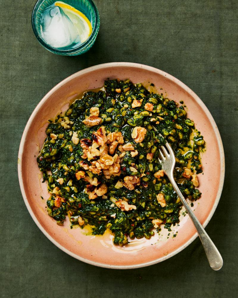 A bowl of attractive-looking risotto with green leaves, sseen from directly above