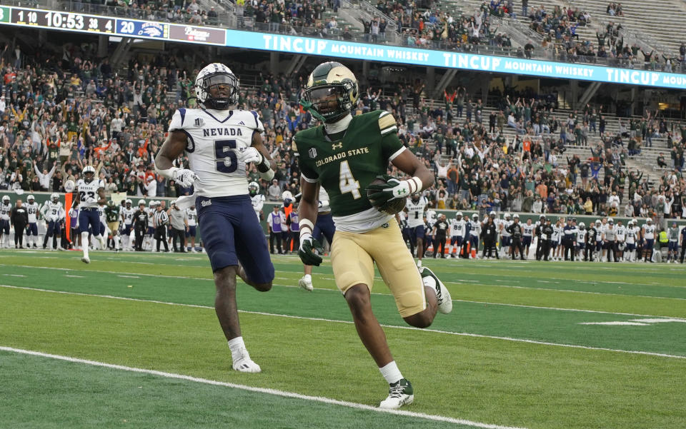 ADDS NEVADA DEFENSIVE BACK EMANY JOHNSON (5) - Colorado State wide receiver Louis Brown IV (4) runs into the end zone for a touchdown after catching a pass in front of Nevada defensive back Emany Johnson (5) in the second half of an NCAA college football game Saturday, Nov. 18, 2023, in Fort Collins, Colo. (AP Photo/David Zalubowski)