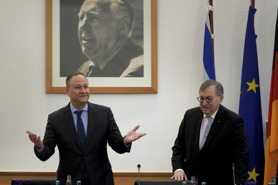 The Second Gentleman of the United States, Douglas Emhoff, left, stands next to the council's vice chairman, Abraham Lehrer, as he arrivers for an interfaith roundtable at 'Central Council of Jews in Germany' in Berlin, Germany, Tuesday, Jan. 31, 2023. In the background is a picture of the former council's chairman Ingatz Bubis. (AP Photo/Michael Sohn, pool)