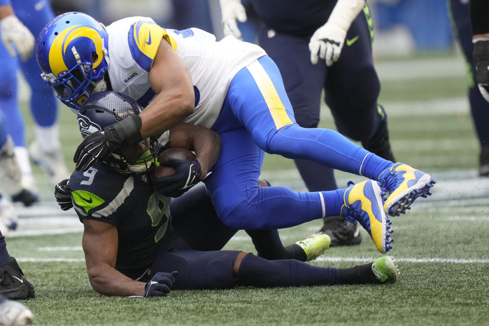 Seattle Seahawks running back Kenneth Walker III (9) is tackled by Los Angeles Rams linebacker Bobby Wagner during the first half of an NFL football game Sunday, Jan. 8, 2023, in Seattle. (AP Photo/Stephen Brashear)