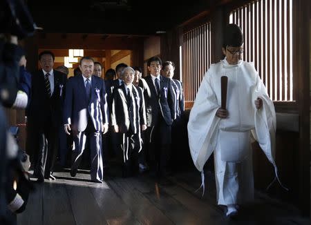 A group of lawmakers including Japan's ruling Liberal Democratic Party (LDP) lawmaker Hidehisa Otsuji (3rd L) are led by a Shinto priest as they visit Yasukuni Shrine in Tokyo October 17, 2014. REUTERS/Yuya Shino