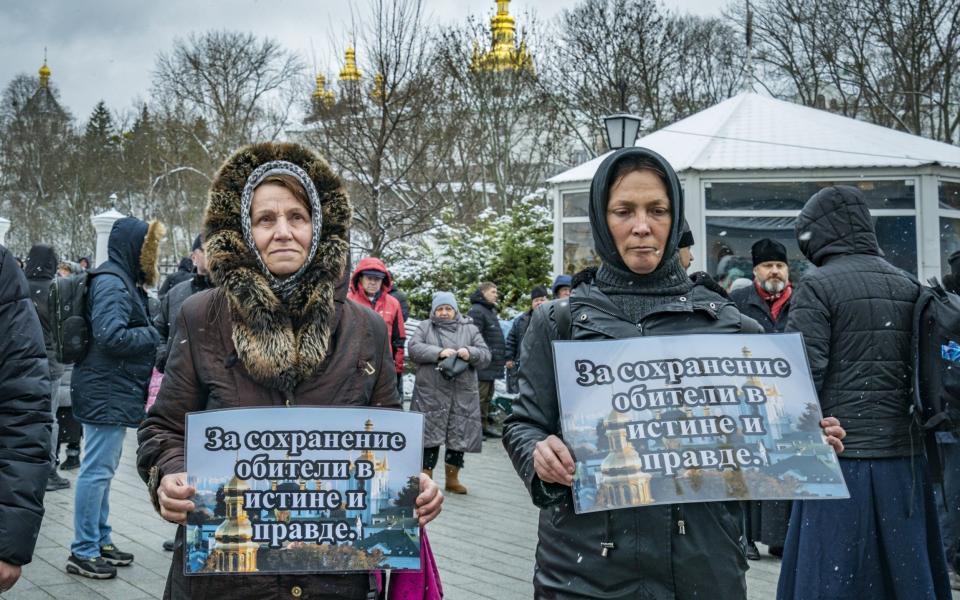 Two women holds banners against the eviction of the monks of the Kyiv-Pechersk Lavra - Celestino Arce/NurPhoto/Shutterstock/Shutterstock