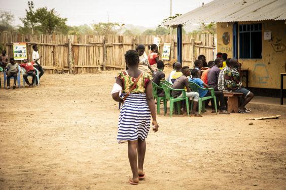 Martha queues up with other children to receive an official document in Yambio saying she has been released from the army