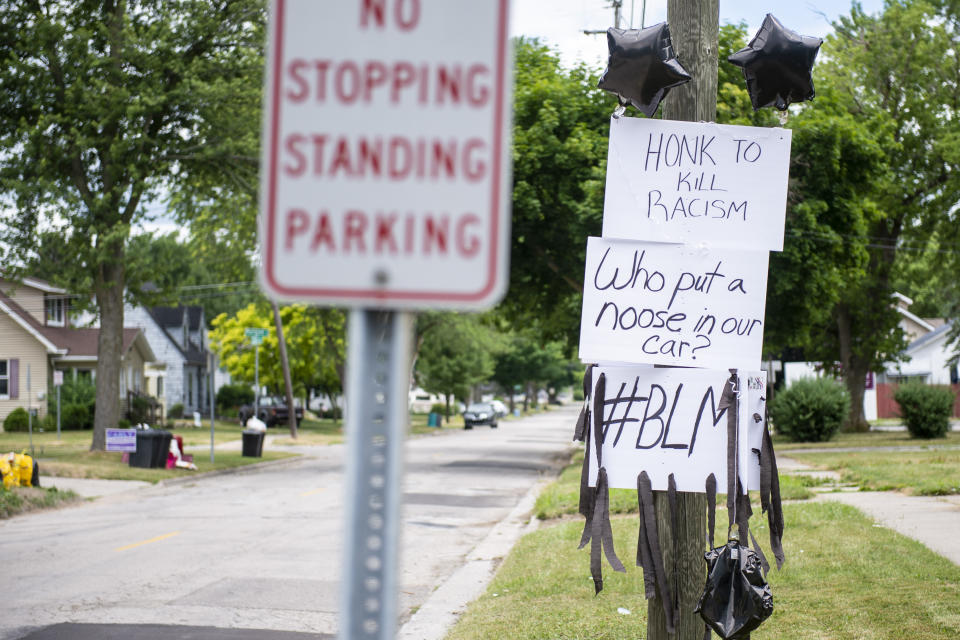 Regina and Donald Simon display signs in their yard in Saginaw on Monday, July 13, 2020. On Sunday, July Donald looked in his vehicle to find what appears to be a noose, with a note attached. A retired Michigan optometrist faces federal charges for allegedly leaving nooses and notes mocking the Black Lives Matter movement inside the mixed-race couple's pickup truck, near or inside several stores and placing threatening phone calls. (Kaytie Boomer/Saginaw News via AP)