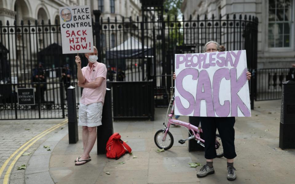 Protesters outside Downing Street, London, as the row over Prime Minister Boris Johnson's top aide Dominic Cummings' Durham trip continues - Yui Mok/PA Wire