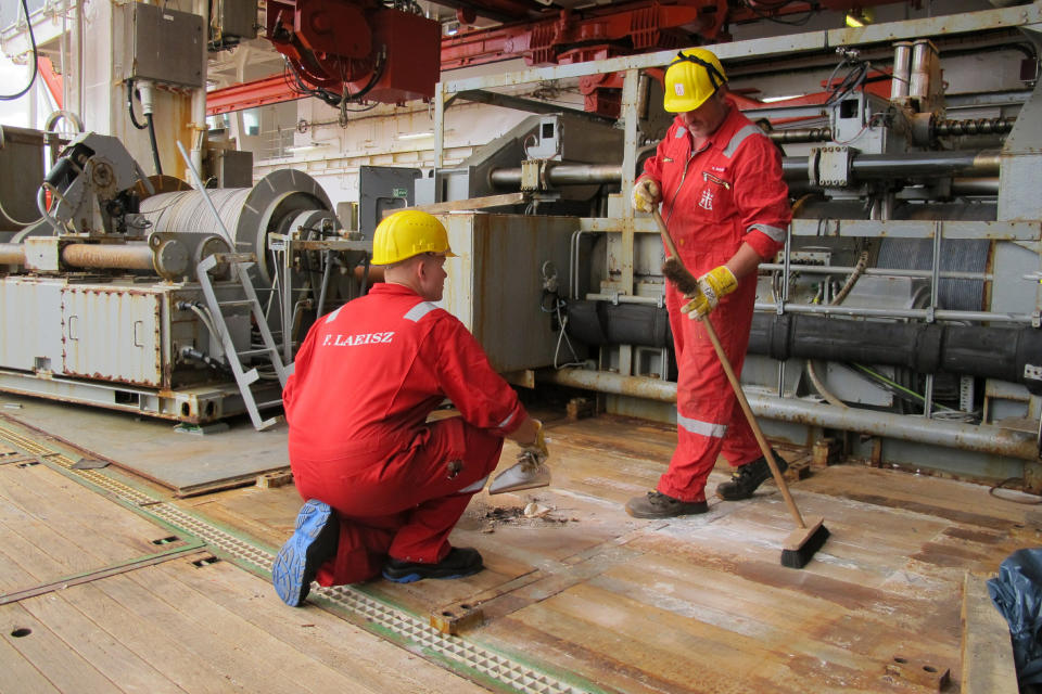 Workers clean the deck after carrying out maintenance on the German Arctic research vessel Polarstern in Bremerhaven, Germany, Wednesday, July 3, 2019. Scientists from 17 nations are preparing for a year-long mission to the central Arctic to study the impact that climate change is having on the frigid far north of the planet. Mission leader Markus Rex said that researchers plan to anchor the German icebreaker RV Polarstern to a large floe and set up camp on the ice as the sea freezes around them, conducting experiments throughout the Arctic winter. (AP Photos/Frank Jordans)