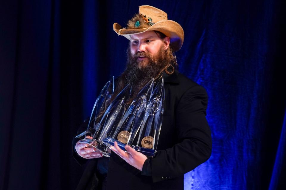 Chris Stapleton shows off his haul from the 55th CMA Awards at Bridgestone Arena in Nashville, Tenn., Wednesday, Nov. 10, 2021.