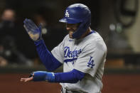 Los Angeles Dodgers' Chris Taylor celebrates after scoring on a single by Corey Seager during the eighth inning in Game 4 of the baseball World Series against the Tampa Bay Rays Saturday, Oct. 24, 2020, in Arlington, Texas.(AP Photo/Eric Gay)