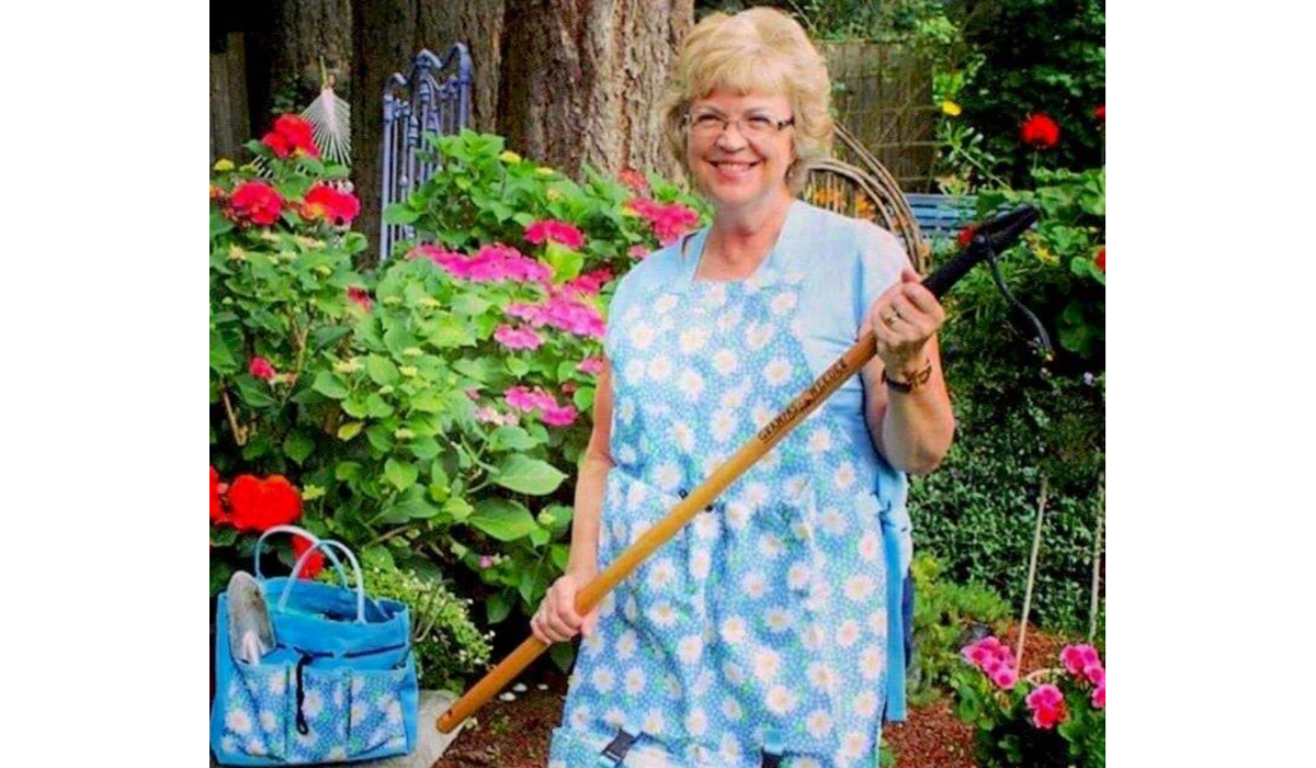 Woman in a garden with a Grampa's Weeder.