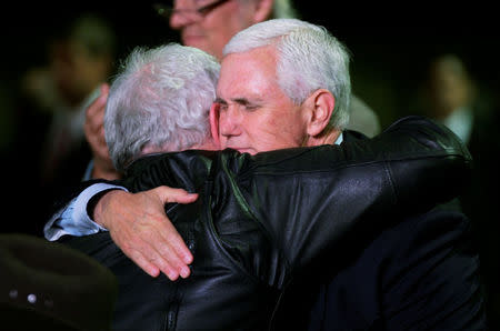 U.S. vice-president Mike Pence (R) hugs Stephen Willeford, the man who shot the shooter in the First Baptist Church of Sutherland Springs in Floresville, Texas, November 8, 2017. REUTERS/Rick Wilking