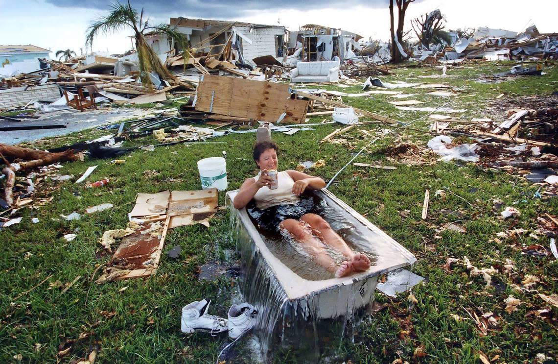 In ‘Untitled,’ shot in 1992, Marjorie Conklin cools off in a tub of water filled with a hose, surrounded by what’s left of her south Miami-Dade County home several days after the destruction of Hurricane Andrew.