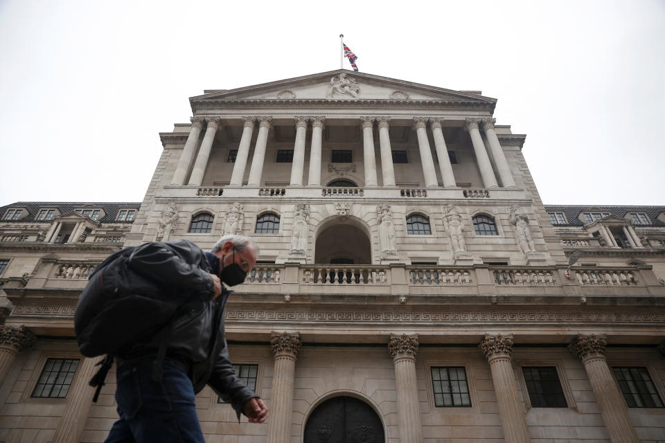 A person walks past the Bank of England in the City of London financial district in London, Britain, January 23, 2022. REUTERS/Henry Nicholls