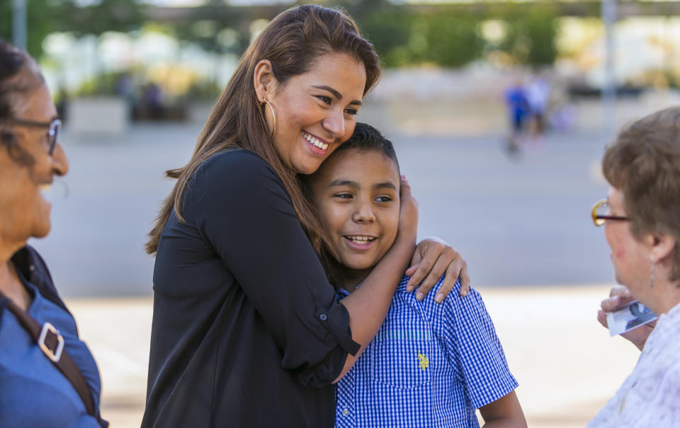 FILE - Immigrants from El Salvador, Adan and his mother, Roxana, hug after attending the "Mass in Recognition of All Immigrants," an annual Mass at the Cathedral of Our Lady of the Angels in Los Angeles, on June 24, 2018. After he made it across the U.S.-Mexico border in 2016, Adan was reunited with his mother who had arrived in the United States earlier. It took him three attempts to seek asylum before he made it into the U.S. In December 2021, the Justice Department withdrew from settlement talks over financial compensation for their suffering but hasn't ruled out an agreement. (AP Photo/Damian Dovarganes, File)