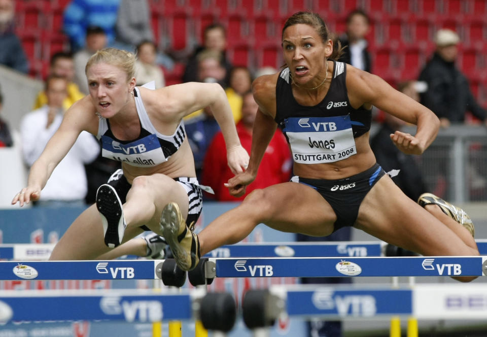 FILE - In this Saturday, Sept. 13, 2008, file photo, Lolo Jones, of the United States, right, and Sally McLellan, from Australia, clear a hurdle in the women's 100-meter hurdles race at the IAAF World Athletics Final in Stuttgart, Germany. Jones hasn’t returned to China since 2008, since one bad step in what was then the biggest race of her life cost her an Olympic gold medal. Her stance might change in 2022. (AP Photo/Thomas Kienzle, File)