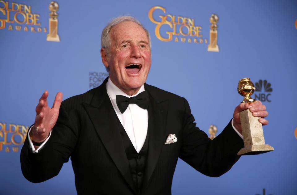 Producer Jerry Weintraub poses backstage with the award for Best TV Movie or Mini-Series for "Behind the Candelabra" at the 71st annual Golden Globe Awards in Beverly Hills