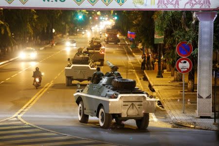 Army vehicles are seen along a street in Phnom Penh, Cambodia August 11, 2017. REUTERS/Stringer NO SALES NO ARCHIVES