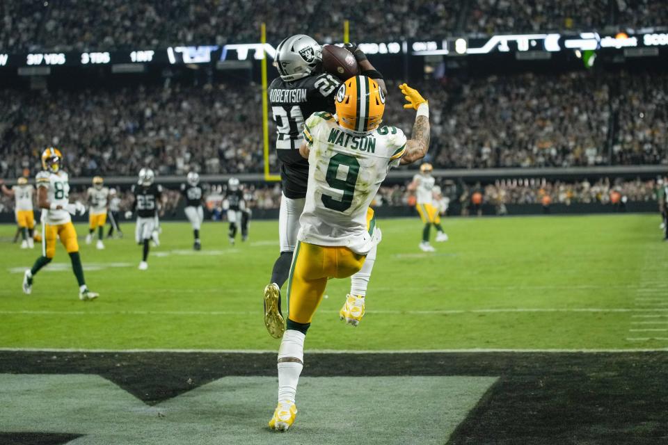 Las Vegas Raiders' Amik Robertson intercepts a pass in front of Green Bay Packers' Christian Watson during the second half of an NFL football game Monday, Oct. 9, 2023, in Las Vegas. The Raiders won 17-13. (AP Photo/John Locher)