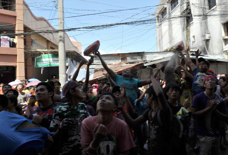 Residents scramble for looted goods in Tacloban, central Philippines, on November 10, 2013, after the city was devastated by Typhoon Haiyan