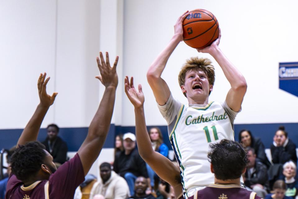 Indianapolis Cathedral High School junior Brady Koehler (11) shoots over Brebeuf Jesuit Preparatory High School defenders during the second half of an IHSAA basketball game, Friday, Dec. 1, 2023, at Cathedral. Cathedral won, 79-63.